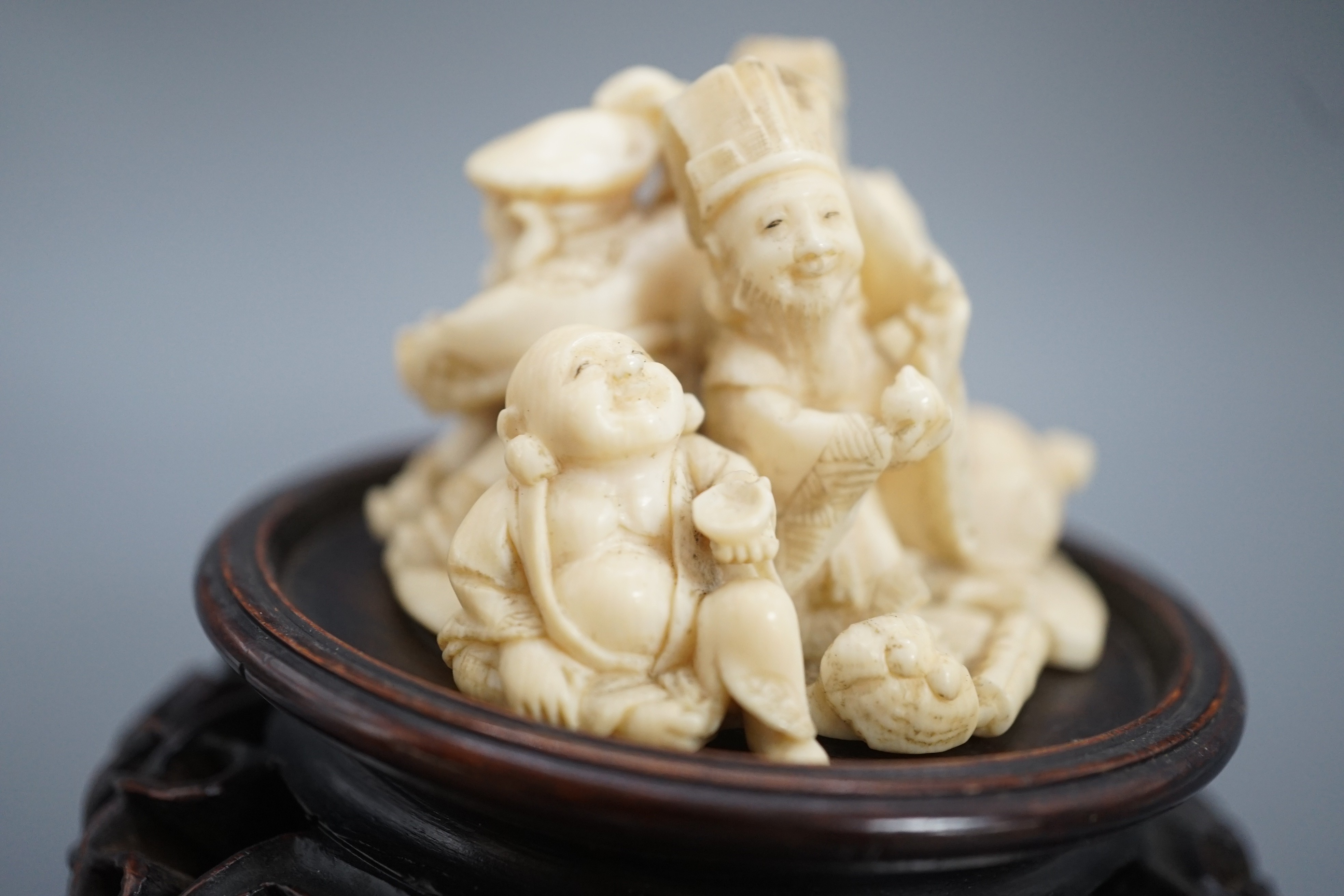 A Japanese ivory okimono of four of the Gods of Happiness, signed Gyokuzan, early 20th century, 6cm